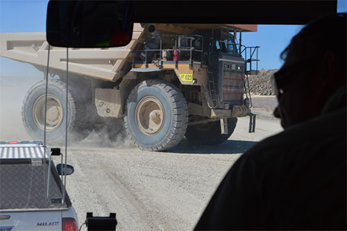 Photo 4. Give Way! to the house-sized truck delivering another load of gold ore to the feedstock pile.