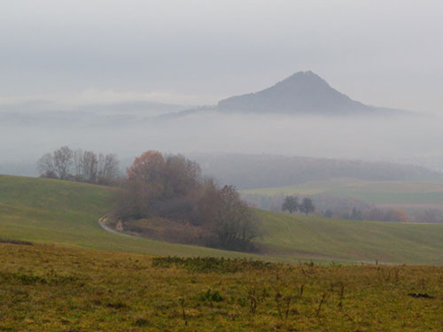 Figure 1. The first stop was a misty  overview looking towards the south with in the distance a suggestion of snowy crags – the Alps.